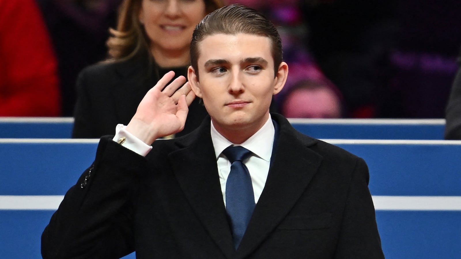 Barron Trump gestures after being acknowledged by his father US President Donald Trump during the inaugural parade inside Capital One Arena, in Washington, DC, on January 20, 2025. (Photo by ANGELA WEISS / AFP) (Photo by ANGELA WEISS/AFP via Getty Images)