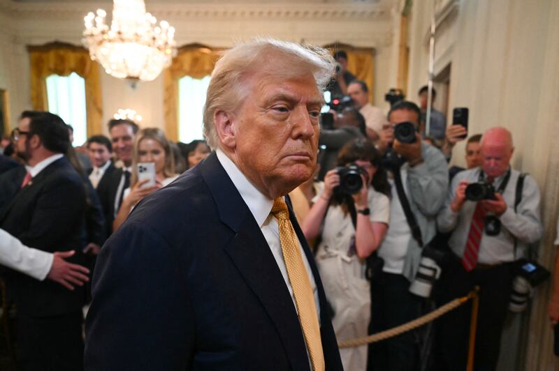 US President Donald Trump speaks to reporters after signing the "Halt All Lethal Trafficking of Fentanyl Act," which strengthens prison sentences for fentanyl traffickers, in the East Room of the White House