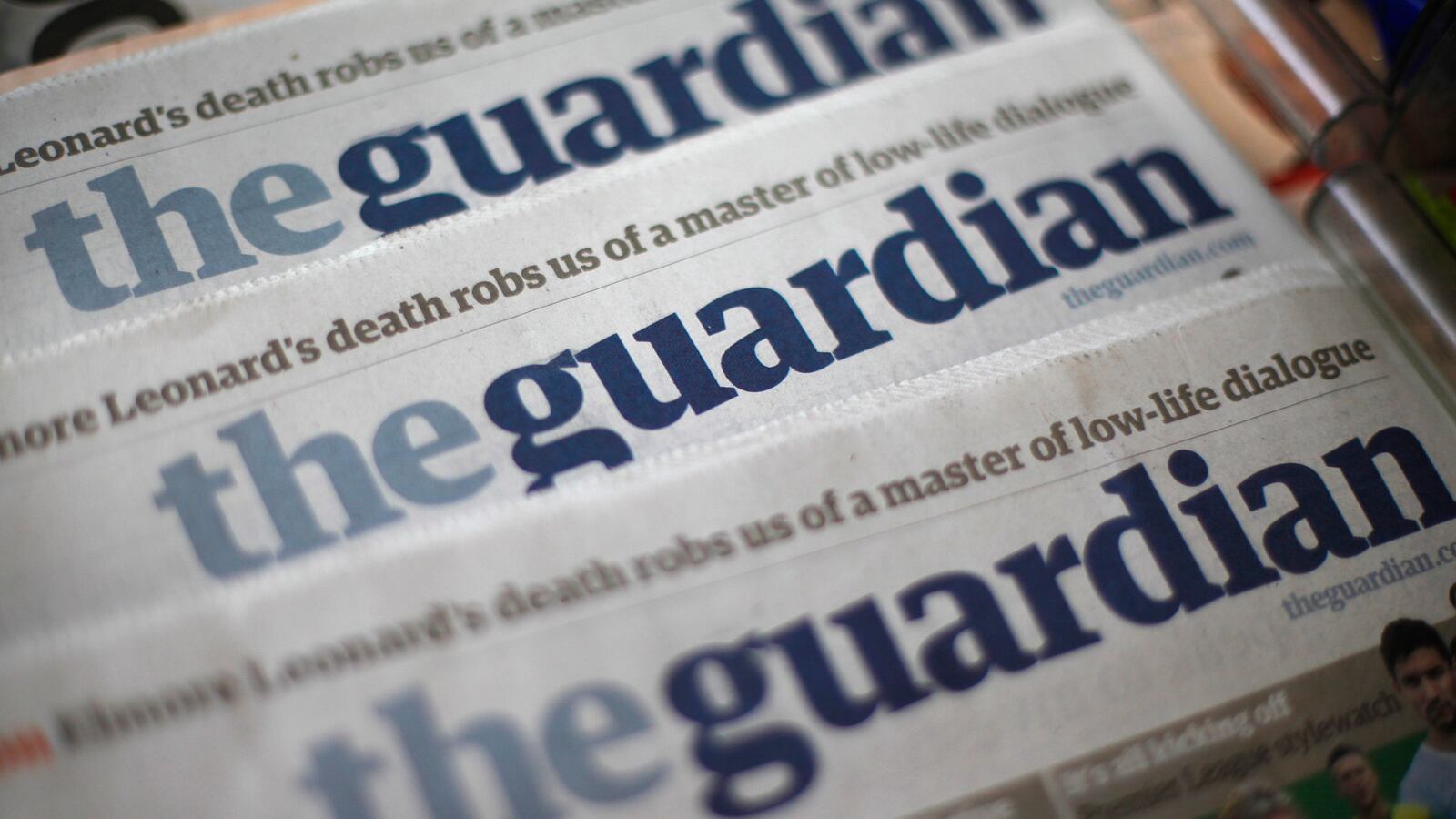 Copies of the Guardian newspaper are displayed at a news agent in London, Aug. 21, 2013.