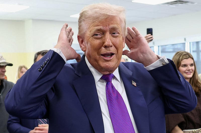 U.S. President Donald Trump checks his hair before sitting down for a podcast interview at the Varsity restaurant in Rome, Georgia, U.S., February 19, 2026.