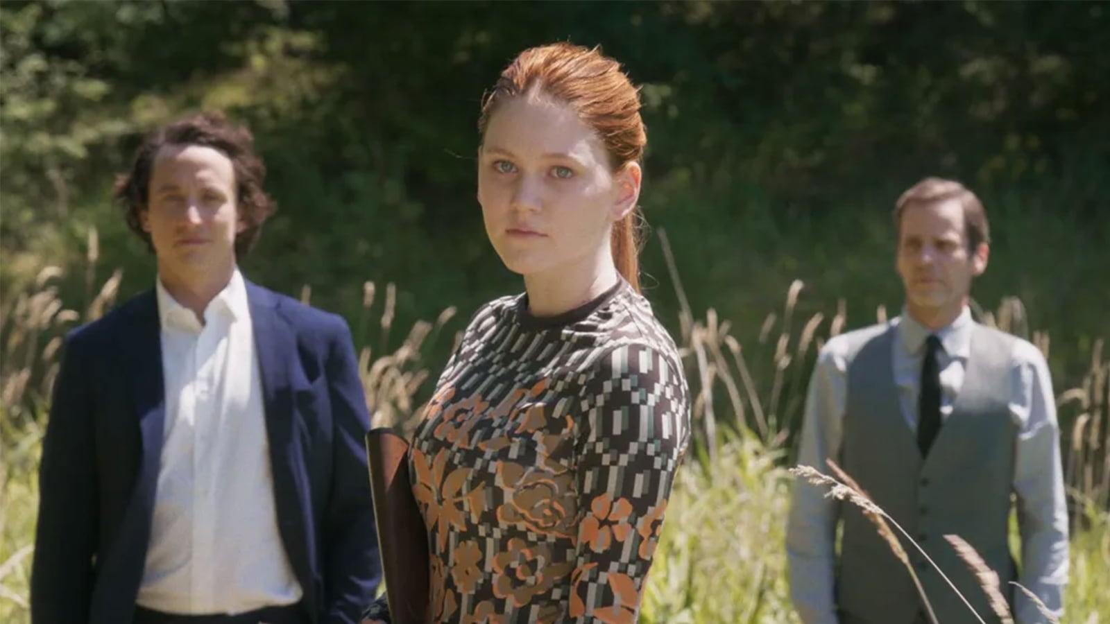 Three people stand in a field in a still from 'Veni Vidi Vici'