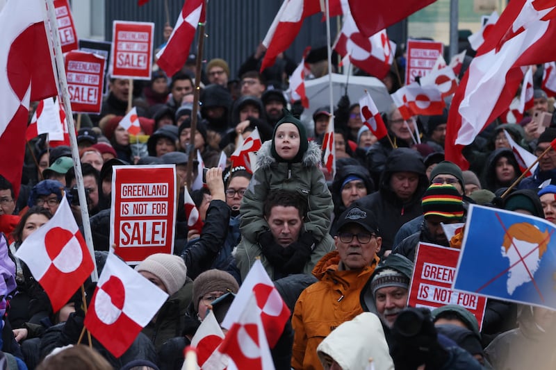 People hold Greenlandic flags as they gather to march in protest against U.S. President Donald Trump and his announced intent to acquire Greenland on January 17, 2026 in Nuuk, Greenland.
