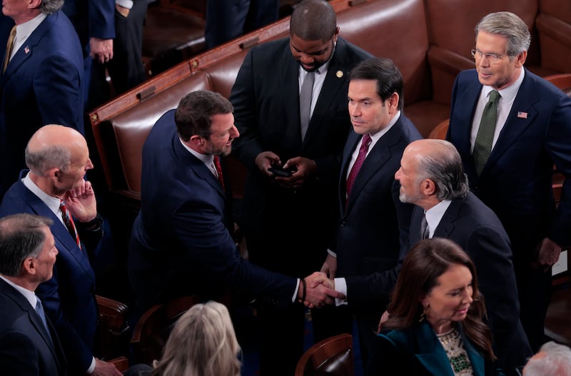 WASHINGTON, DC - FEBRUARY 24: U.S. Secretary of Commerce Howard Lutnick (R) shakes hands with Sen. Markwayne Mullin (R-OK) along Secretary of State Marco Rubio and U.S. Treasury Secretary Scott Bessent as President Donald Trump delivers his State of the Union address during a Joint Session of Congress at the U.S. Capitol on February 24, 2026, in Washington, DC. Trump delivered his address days after the Supreme Court struck down the administration's tariff strategy and amid a U.S. military buildup in the Persian Gulf threatening Iran. (Photo by Chip Somodevilla/Getty Images)