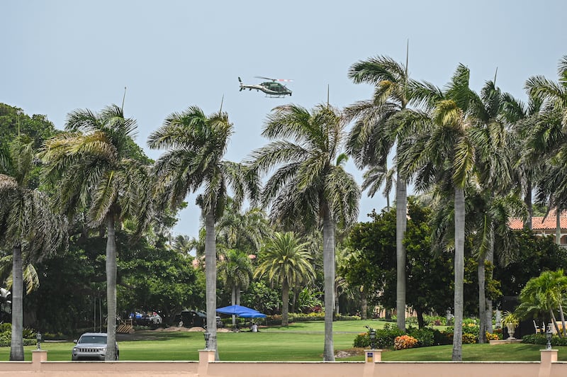 A helicopter flies near the residence of former US President Donald Trump at Mar-A-Lago in Palm Beach, Florida, on August 9, 2022. Former US President Donald Trump said on August 8, 2022, that his Mar-A-Lago residence in Florida was being "raided" by FBI agents in what he called an act of "prosecutorial misconduct." (Photo by Giorgio VIERA / AFP) (Photo by GIORGIO VIERA/AFP via Getty Images)
