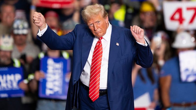 TOPSHOT - Former US President and Republican presidential candidate Donald Trump dances to a song as he leaves a rally at 1st Summit Arena at the Cambria County War Memorial in Johnstown, Pennsylvania, on August 30, 2024. (Photo by ROBERTO SCHMIDT / AFP) (Photo by ROBERTO SCHMIDT/AFP via Getty Images)