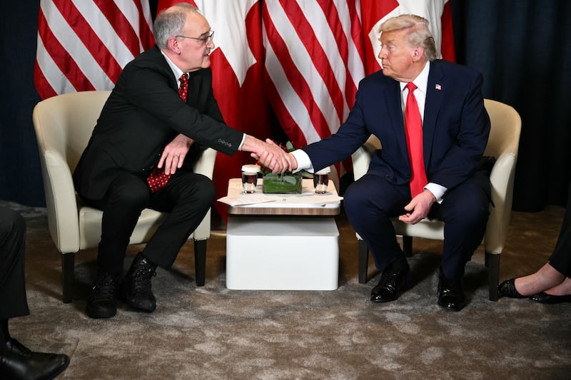 Trump shakes hands with Swiss President Guy Parmelin.