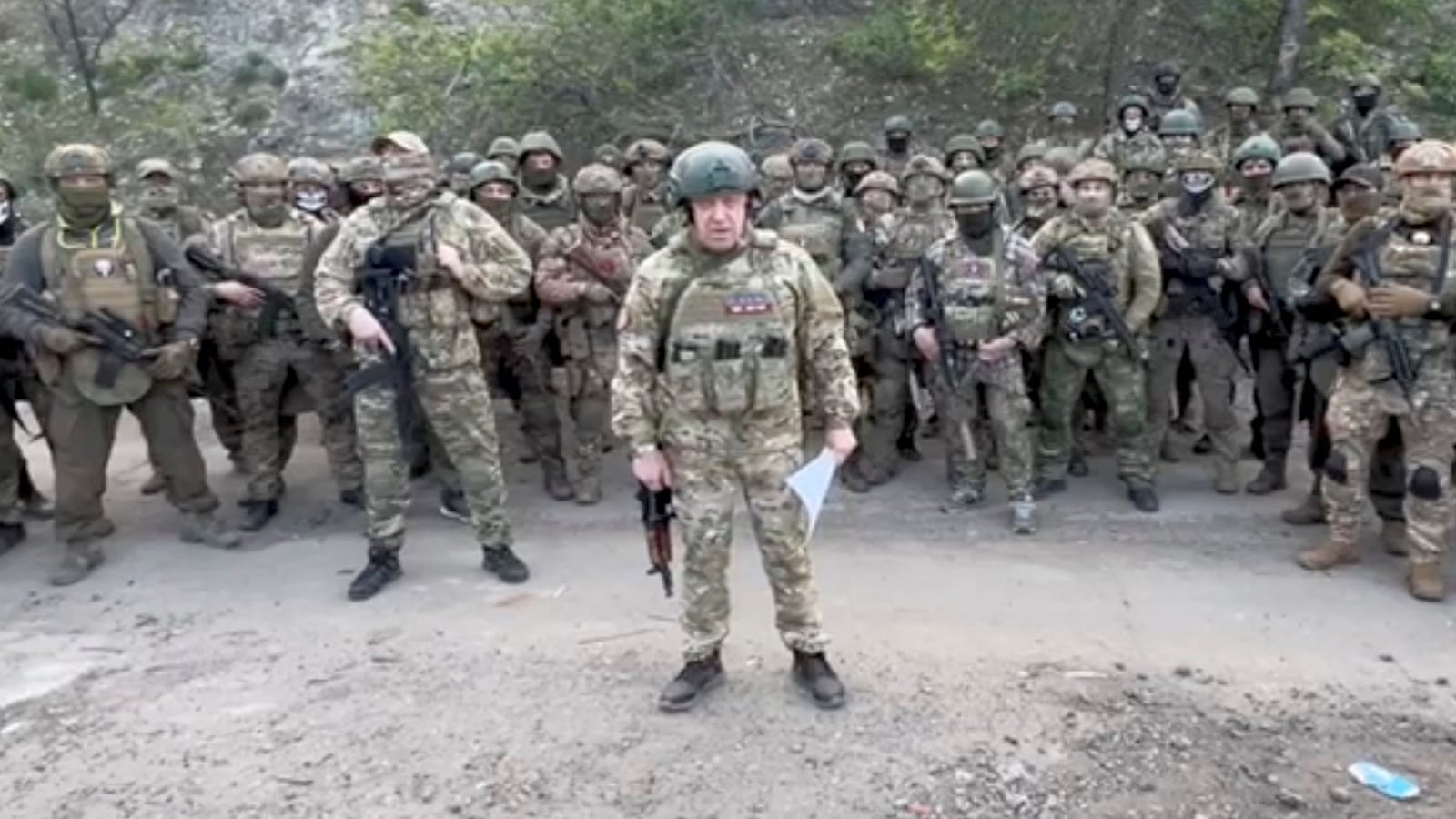 Yevgeny Prigozhin makes a statement as he stand next to Wagner fighters in an undisclosed location in the course of Russia-Ukraine conflict, in this still image taken from video released May 5, 2023.