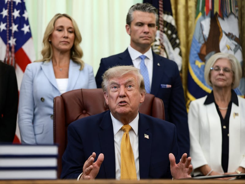 U.S. President Donald Trump answers questions from the media after signing an executive order establishing the President's Military Spouse Commission to be chaired by Jennifer Rauchet, wife of Secretary of Defense Pete Hegseth, in the Oval Office at the White House in Washington, D.C., U.S., August 3, 2026. REUTERS/Evelyn Hockstein