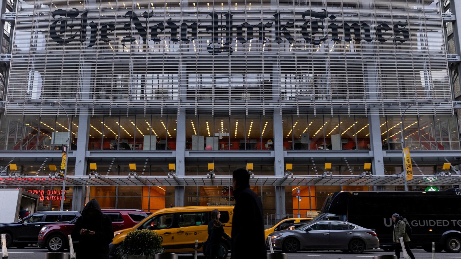 Pedestrians walk by the New York Times building in Manhattan, New York, U.S., December 8, 2022