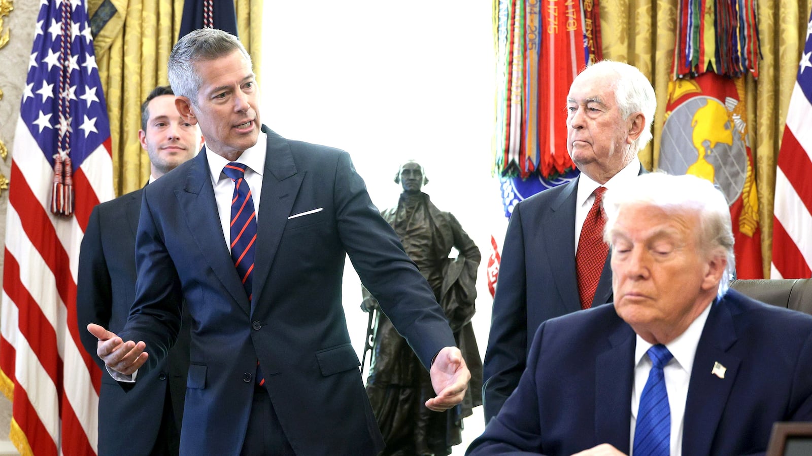 U.S. Secretary of Transportation Sean Duffy speaks alongside Roger Penske, Chair of the Penske Corporation, and U.S. President Donald Trump