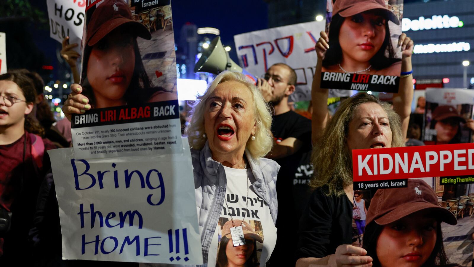 Protesters hold signs and call for release of hostages held in Gaza.