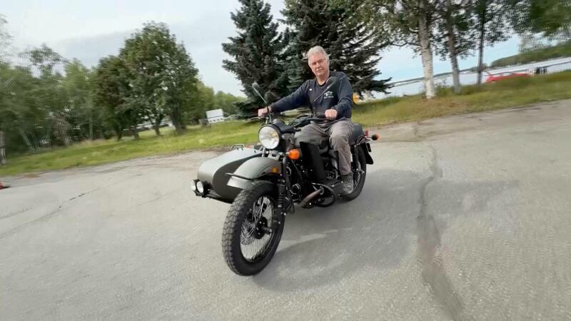 Alaska resident Mark Warren rides his new Ural motorcycle, a gift from Russian President Vladimir Putin, handed over by a Russian Embassy official, in Anchorage, Alaska, on August 18, 2025.