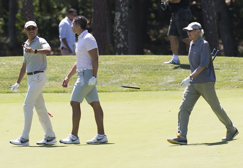 US President Barack Obama walks alongside Cyrus Walker and comedian Larry David as they play golf at Farm Neck Golf Club in Oak Bluffs on Martha's Vineyard.