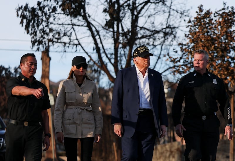 U.S. President Donald Trump and first lady Melania Trump walk with Captain Jeff Brown, Chief of LAFD Station 69 and Jason Hing, Chief Deputy of Emergency Services, Los Angeles Fire Department, as they tour the Pacific Palisades neighborhood that was damaged by the Palisades Fire, in Los Angeles, California, U.S., January 24, 2025. REUTERS/Leah Millis