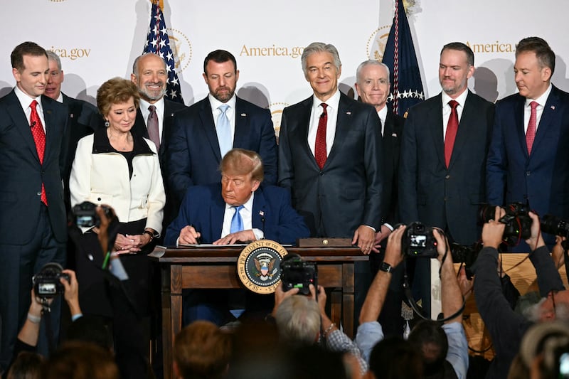 US President Donald Trump signs an executive order related to the America.gov website during an event to unveil the website, at the Andrew W. Mellon Auditorium in Washington, DC, on September 29, 2026. (Photo by Jim WATSON / AFP via Getty Images)