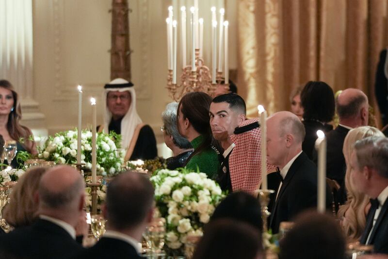 Portuguese soccer star Cristiano Ronaldo listens as President Donald Trump speaks at a dinner with Saudi Crown Prince Mohammed bin Salman