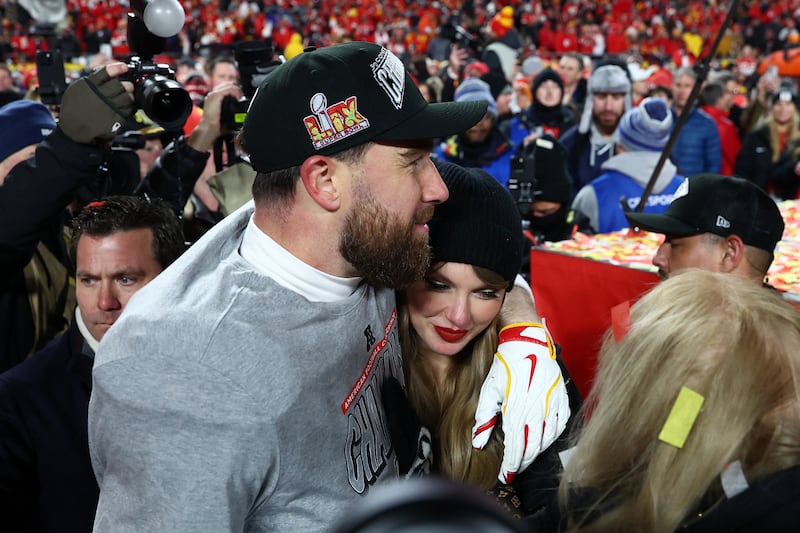 Taylor Swift and Travis Kelce hug after the AFC Championship game against the Buffalo Bills at GEHA Field at Arrowhead Stadium.