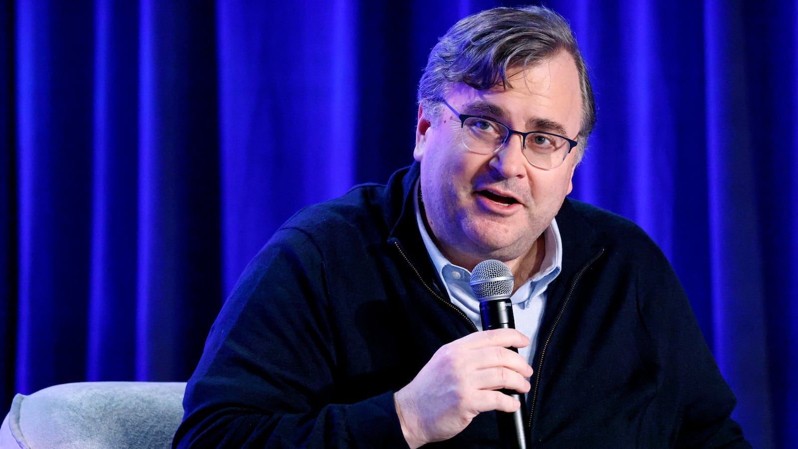 Reid Hoffman speaks on a stage.