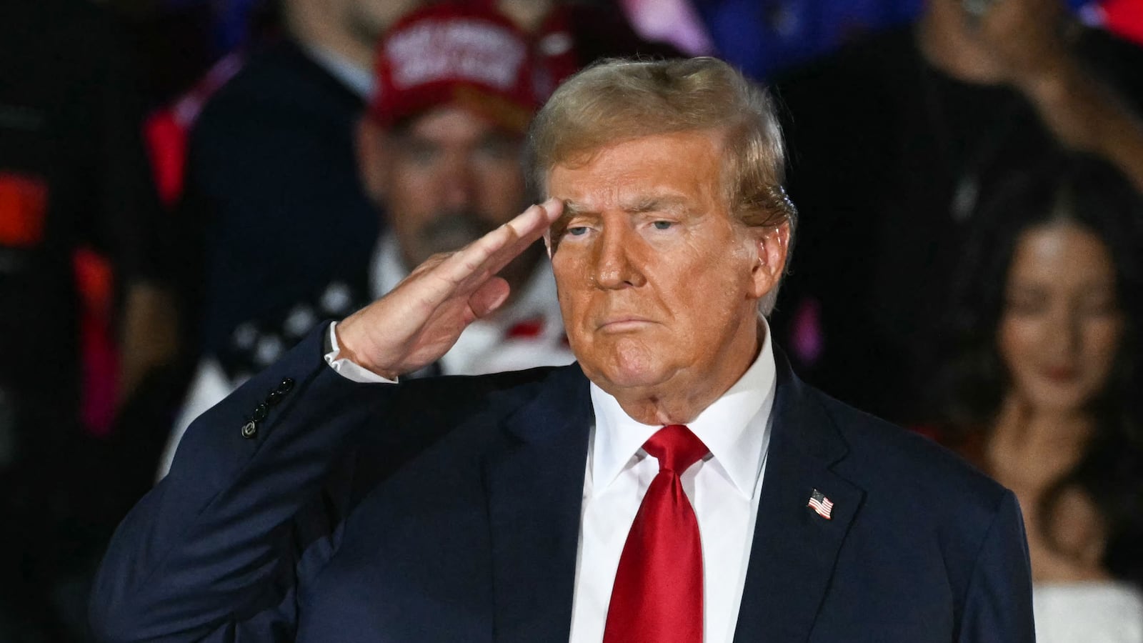 Former US President and Republican presidential candidate Donald Trump does a military salute during a campaign rally as he celebrates his 78th birthday at West Palm Convention Center, in West Palm Beach, Florida, on June 14, 2024.