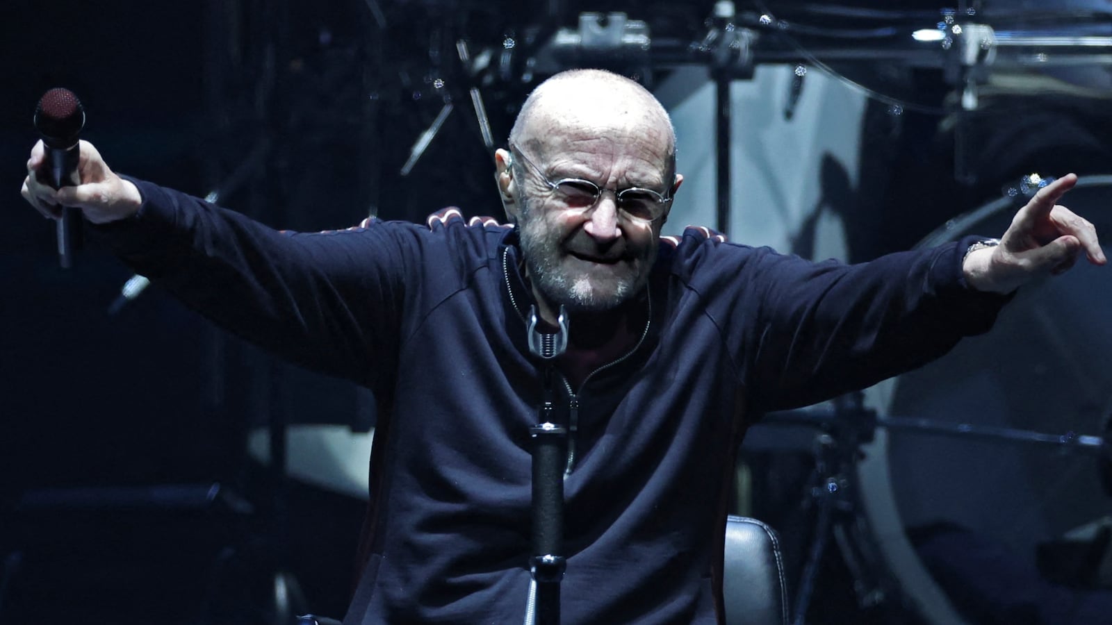 British singer Phil Collins (C) performs on stage during "The last domino" tour of the British rock band Genesis at the Paris La Defense Arena, in Nanterre, northeastern France, on March 16, 2022. (Photo by THOMAS COEX / AFP) (Photo by THOMAS COEX/AFP via Getty Images)