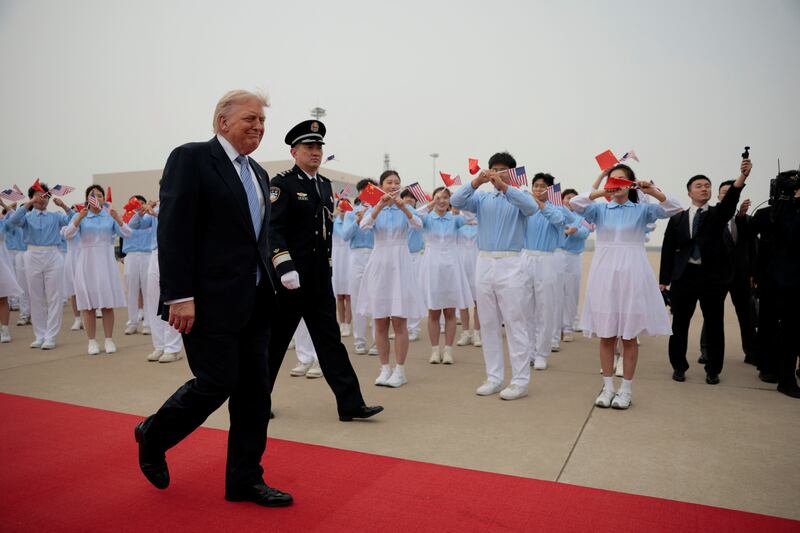 U.S. President Donald Trump reacts as he walks towards Air Force One at Beijing Capital International Airport, in Beijing, China, May 15, 2026.