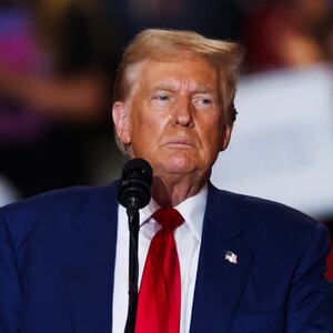 Donald Trump stares forward on stage at a campaign event.