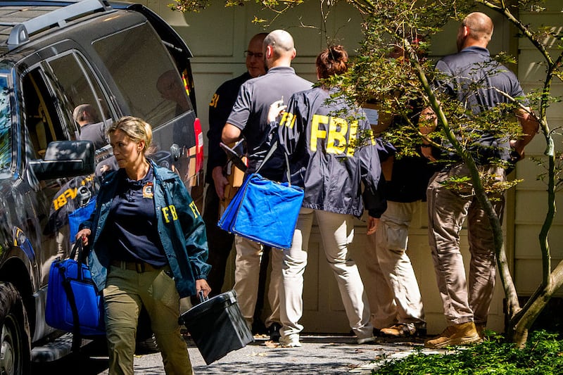 FBI agents depart with bags and boxes of material at the home of John Bolton, former national security adviser to President Trump, after conducting a search of the home for more than seven hours, August 22, 2025 in Bethesda, Maryland. The FBI conducted an early morning court-authorized search of Bolton's home. (Photo by Andrew Harnik/Getty Images)