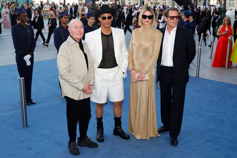 (From L) US producer David Geffen, Donovan Michaels, British model Lady Jemma Mornington and French businessman Arpad Busson poses during a photocall upon arrival to attend the Spring/Summer 2025 menswear ready to wear joint fashion show hosted by Vogue World as part of Paris Fashion Week at Place Vendome in Paris, on June 23, 2024, ahead of the upcoming Paris 2024 Olympic Games. (Photo by Geoffroy VAN DER HASSELT / AFP) (Photo by GEOFFROY VAN DER HASSELT/AFP via Getty Images)
