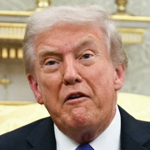 US President Donald Trump shows the floor plan of his planned ballroom.