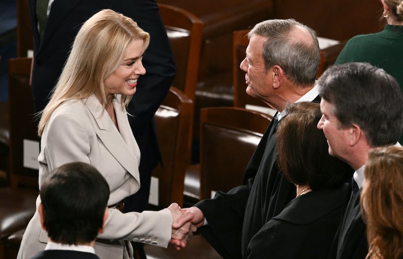 US Attorney General Pam Bondi shakes hands with Chief Justice John Roberts before the arrival of President Donald Trump for the State of the Union address in the House Chamber of the US Capitol in Washington, DC, on February 24, 2026. (Photo by Brendan SMIALOWSKI / AFP via Getty Images)