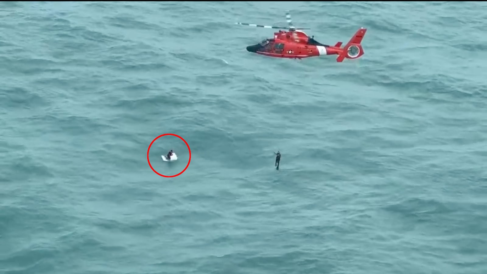 A Coast Guard helicopter rescues a man clinging to a cooler 30 miles off the coast of Florida in the aftermath of Hurricane Milton.