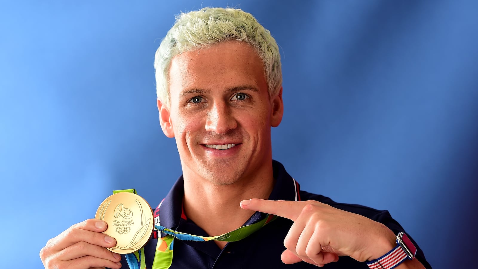 RIO DE JANEIRO, BRAZIL - AUGUST 12: (BROADCAST - OUT) Swimmer, Ryan Lochte of the United States poses for a photo with his gold medal on the Today show set on Copacabana Beach on August 12, 2016 in Rio de Janeiro, Brazil. (Photo by Harry How/Getty Images)