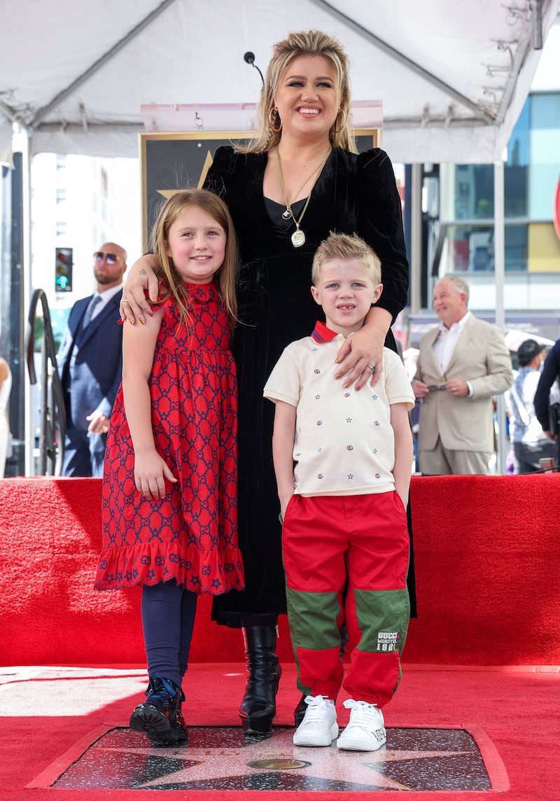 Singer Kelly Clarkson and her children, River Rose and Remington, pose with her star on the Hollywood Walk of Fame in Los Angeles, California, U.S., on September 19, 2022.