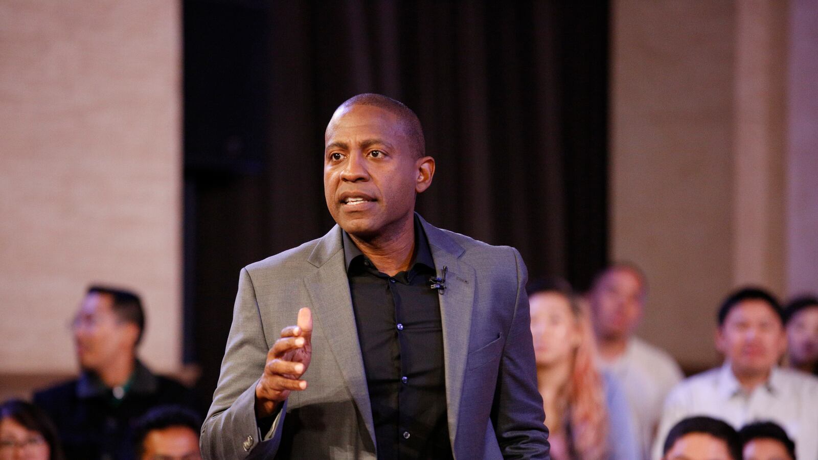 Carlos Watson films a TV debate in 2018.