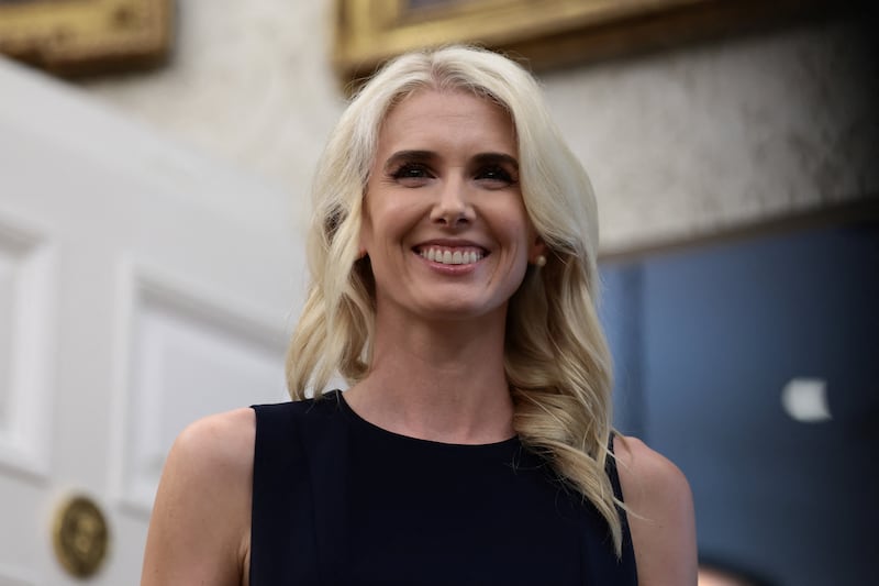U.S. President Donald Trump's executive assistant Natalie Harp looks on as U.S. President Donald Trump holds an event to deliver remarks on his administration's healthcare policies in the Oval Office at the White House in Washington, D.C., U.S., August 31, 2026.