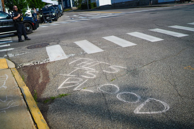 Blood is seen on the pavement at the scene of a shooting involving U.S. Immigration and Customs Enforcement (ICE)
