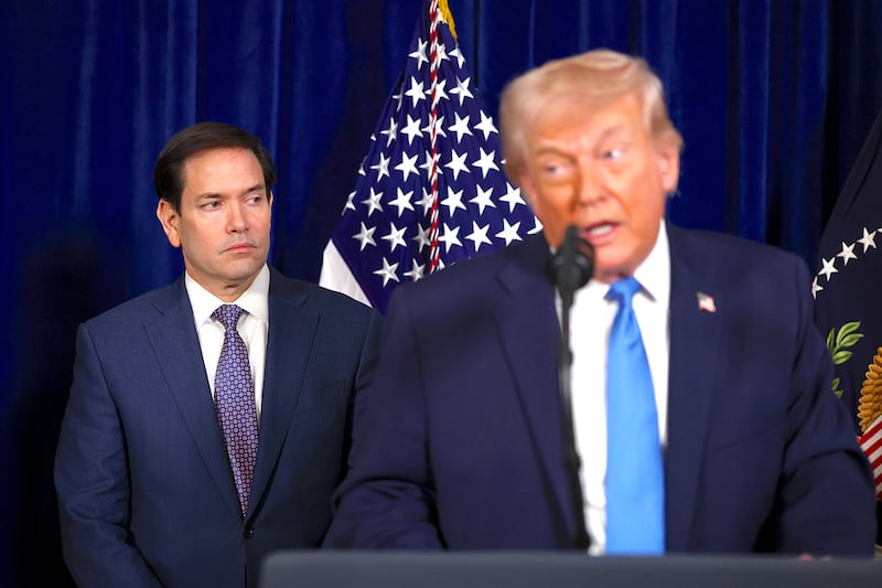 U.S. Secretary of State Marco Rubio listens as U.S. President Donald Trump addresses the media during a news conference at his Mar-a-Lago club on January 03, 2026, in Palm Beach, Florida.