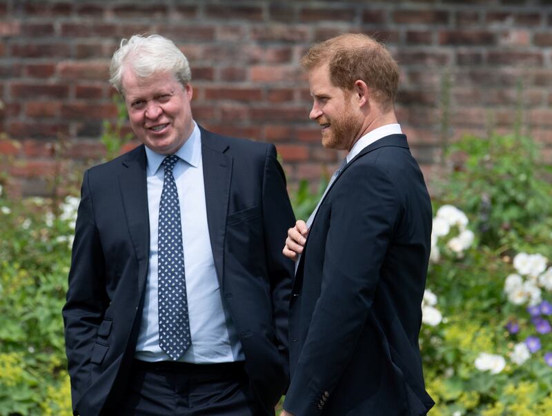 Britain's Prince Harry, Duke of Sussex, talks with his uncle Charles Spencer, 9th Earl Spencer, during the unveiling of a statue commissioned of his mother Diana, Princess of Wales, in the Sunken Garden at Kensington Palace, London, Britain July 1, 2021.
