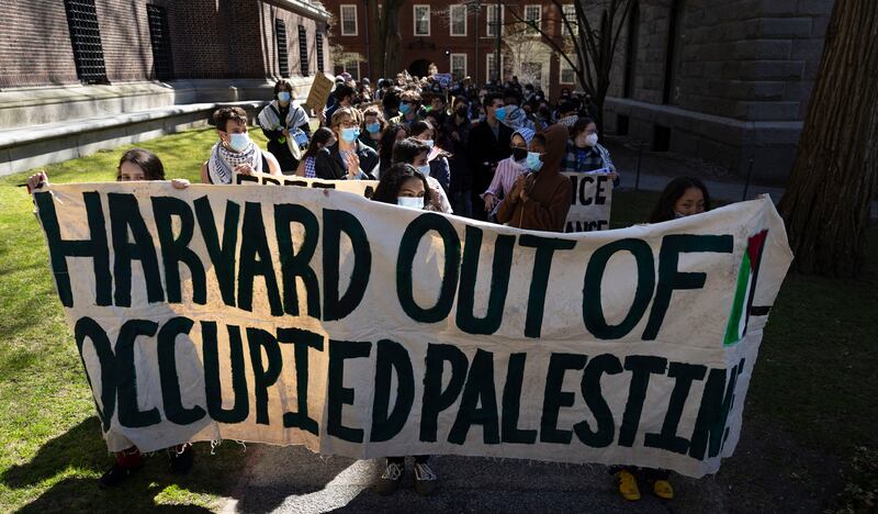 Protesters gather inside Harvard University to show their disapproval of actions taken under the Trump administration.