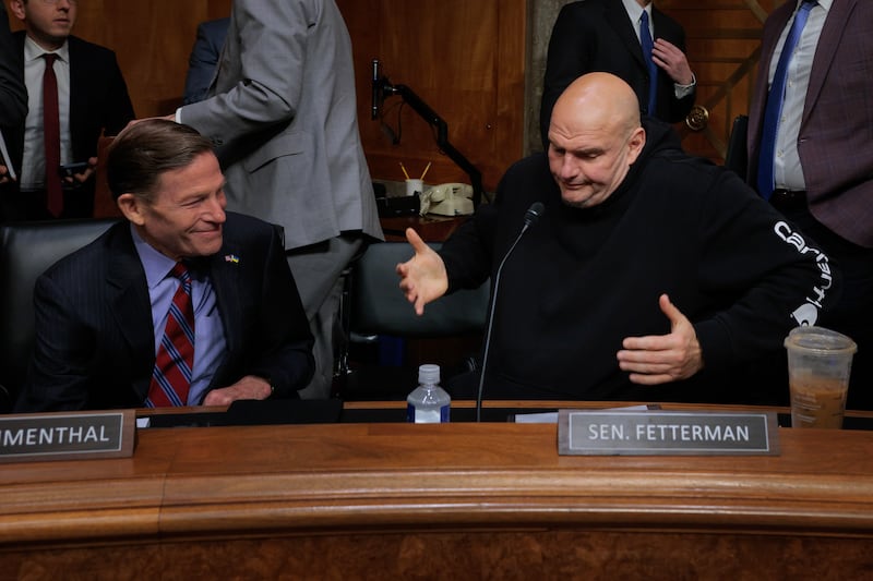 Senate Homeland Security and Governmental Affairs Committee member Sen. John Fetterman shrugs after voting for Sen. Markwayne Mullin to be Secretary of the Department of Homeland Security in committee on March 19, 2026.