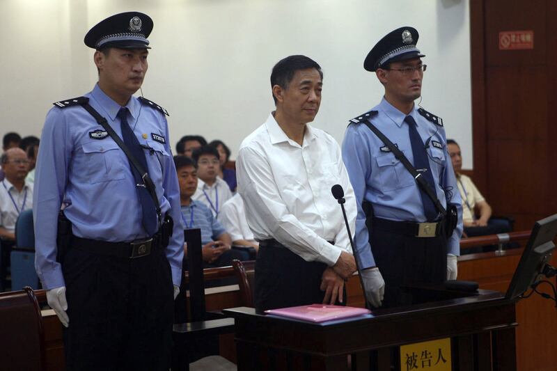 articles/2013/08/23/bo-xilai-s-perfect-show-trial/130823-huang-boxilai-tease_n755tt