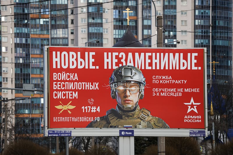 ST PETERSBURG, RUSSIA - 2026/03/27: An outdoor advertising billboard with the slogan "Irreplaceable" and information about recruitment for the unmanned systems units of the Russian Armed Forces has been installed on a street in St. Petersburg. Outdoor advertising across St. Petersburg encourages citizens to enlist in the Russian Armed Forces under contract. Some billboards focus on recruitment for new units such as the Unmanned Systems Troops, highlighting opportunities for specialized training lasting at least three months. The campaign emphasizes technological roles and operator training as part of expanding new military branches. The advertisements are integrated into the urban environment, including near residential areas and public facilities. (Photo by Artem Priakhin/SOPA Images/LightRocket via Getty Images)
