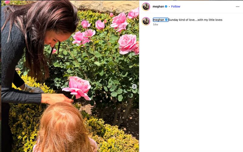 Meghan and Lilibet in a rose garden.