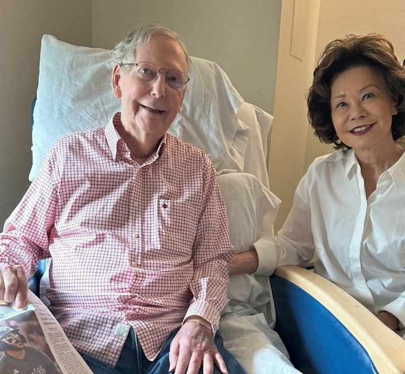 U.S. Senator Mitch McConnell (R-KY) sits with his wife, former United States Secretary of Labor Elaine Chao, while holding what appears to be the July 12 sports section of the Washington Post in a photograph released by his office in Washington, D.C., U.S., July 12, 2026.