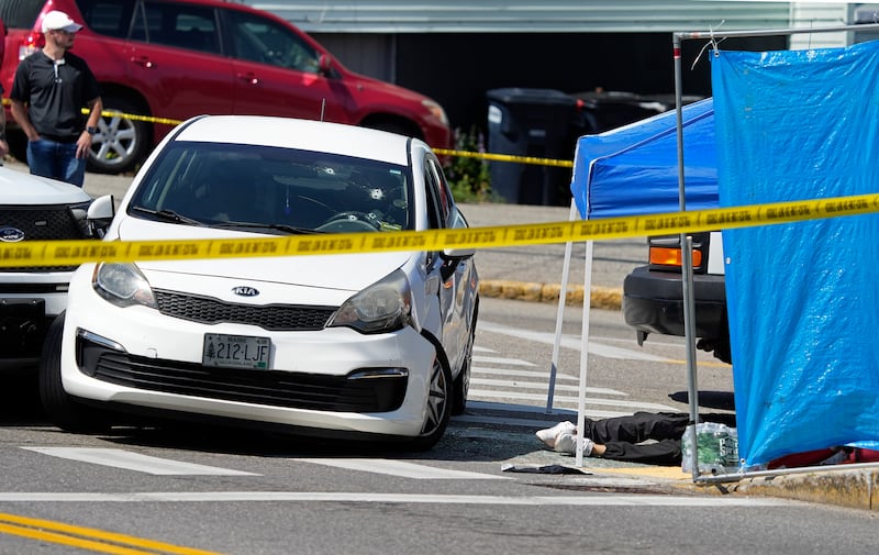 The victim of a fatal shooting that involved U.S. Immigration and Customs Enforcement agents is visible at the scene near the car he was driving