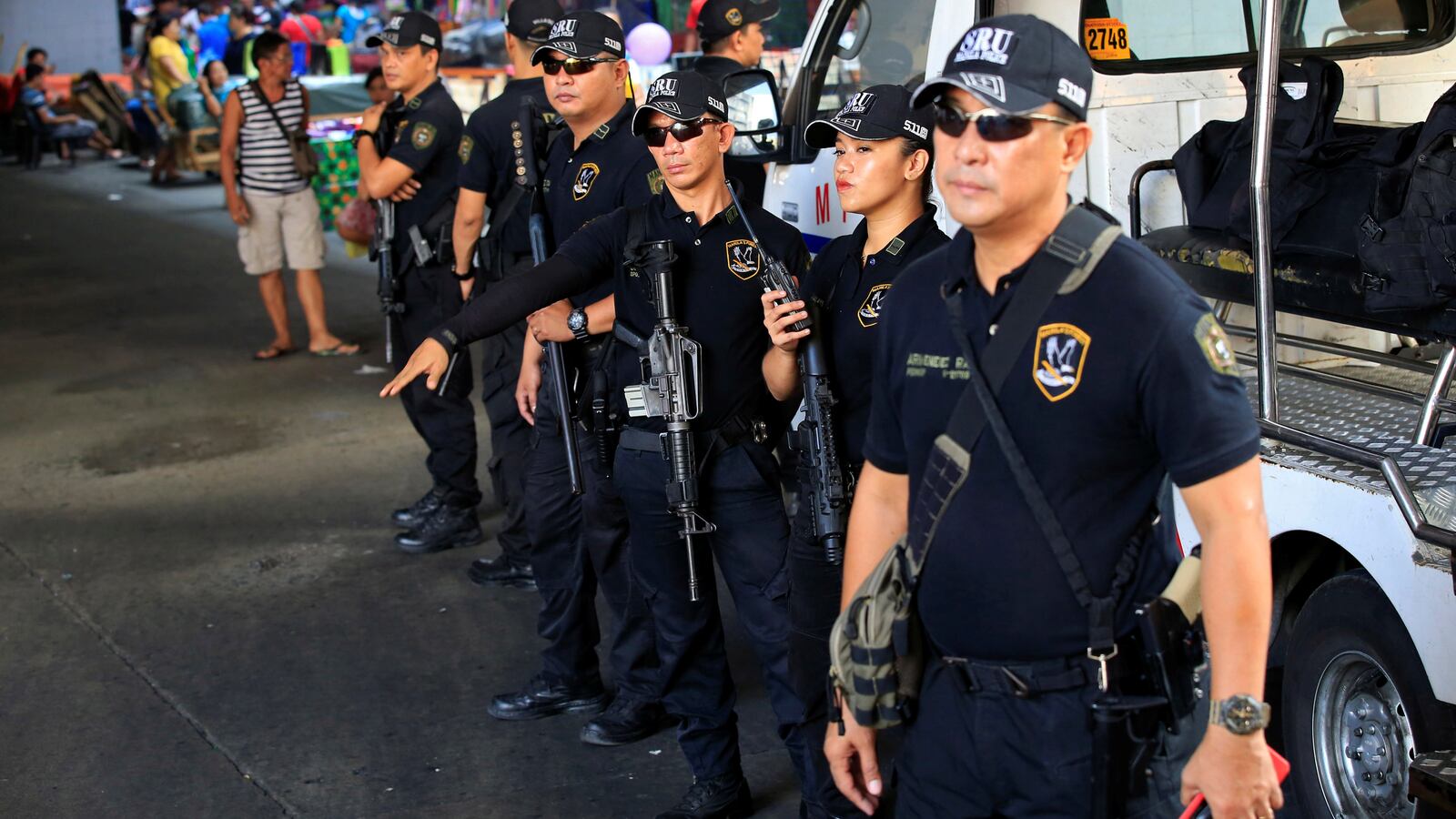 Members of the Philippine National Police Special Reaction Unit gather as part of a police visibility operation along a main road in Metro Manila, Philippines, June 4, 2016.