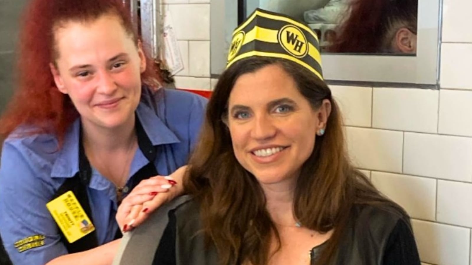 Nancy Mace wearing a Waffle House paper cap.