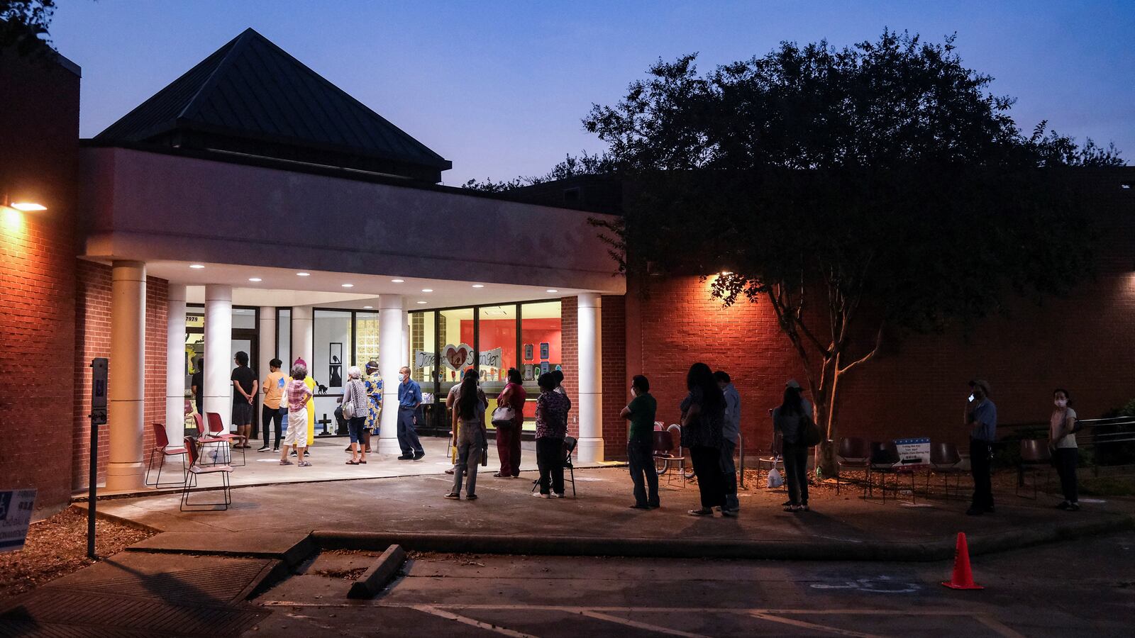 People wait in line to cast their ballots for the upcoming presidential election as early voting begins in Houston, Texas