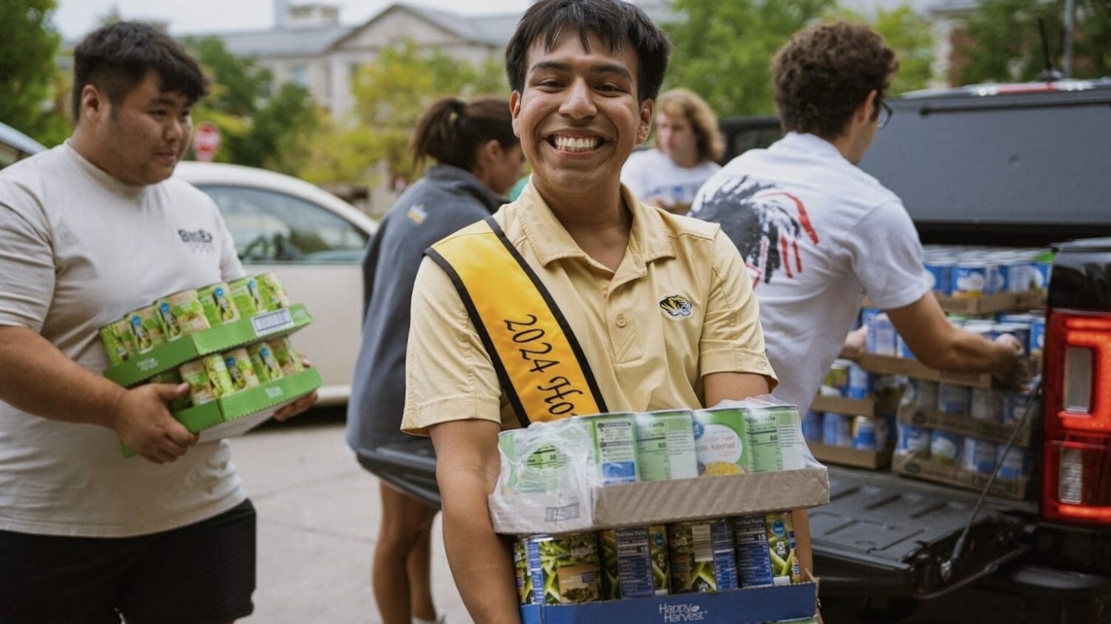 Johnathan Martinez pictured with canned goods donated to a food drive.