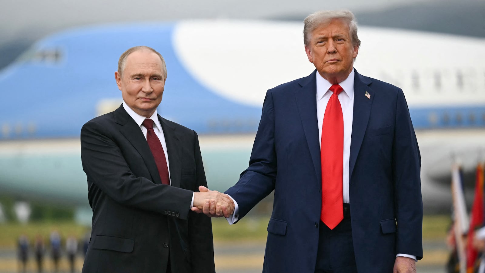 TOPSHOT - US President Donald Trump greets Russian President Vladimir Putin on the tarmac after they arrived at Joint Base Elmendorf-Richardson in Anchorage, Alaska, on August 15, 2025. Putin is in Alaska at the invitation of Trump in his first visit to a Western country since he ordered the 2022 invasion of Ukraine that has killed tens of thousands of people. (Photo by ANDREW CABALLERO-REYNOLDS / AFP) (Photo by ANDREW CABALLERO-REYNOLDS/AFP via Getty Images)